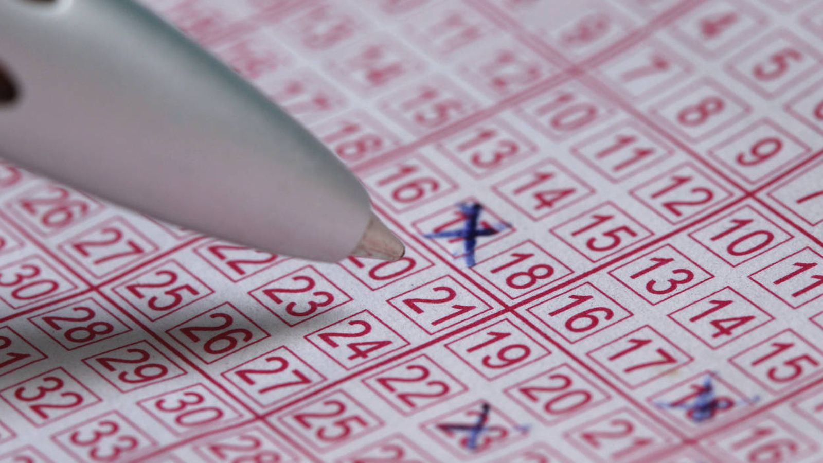 Foto: Un participante de una lotería rellena un boleto. (iStock)