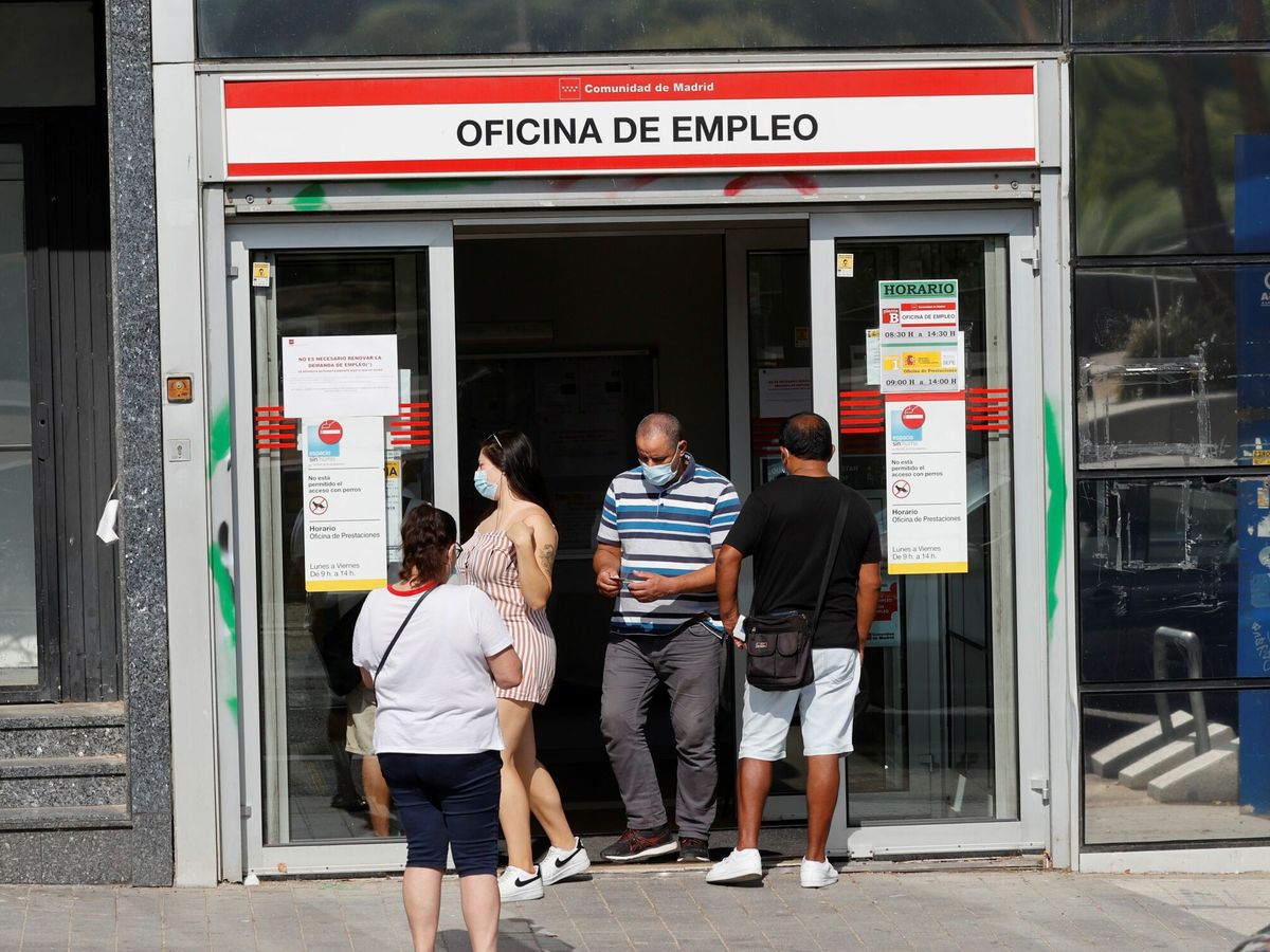 Foto: Varias personas salen y entran en una oficina de empleo en Madrid. (EFE)