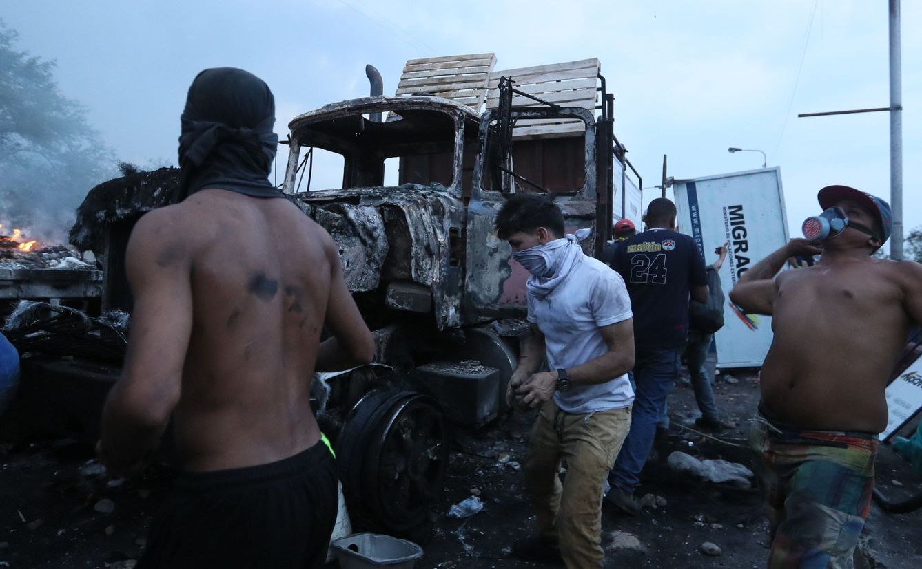 Enfrentamientos en la frontera junto al un camión que transportaba ayuda humanitaria y que fue quemado. (EFE)