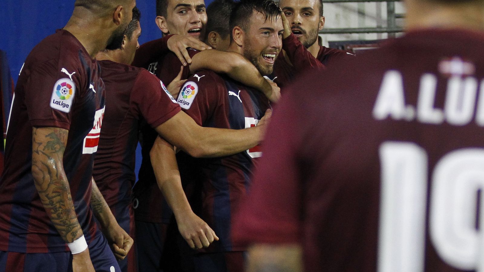 Foto: Enrich, abrazado por sus compañeros tras marcar y Luna, acercándose a ellos (Javier Etxezarreta/EFE).