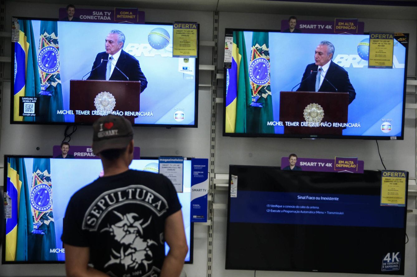 Un hombre observa la transmisión televisada de la alocución del presidente Temer el 18 de mayo de 2017, en una tienda de Sao Paulo. (EFE)