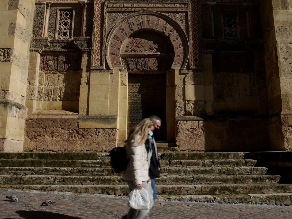 Foto: Dos personas caminan junto a la Mezquita-Catedral de Córdoba. (EFE) 