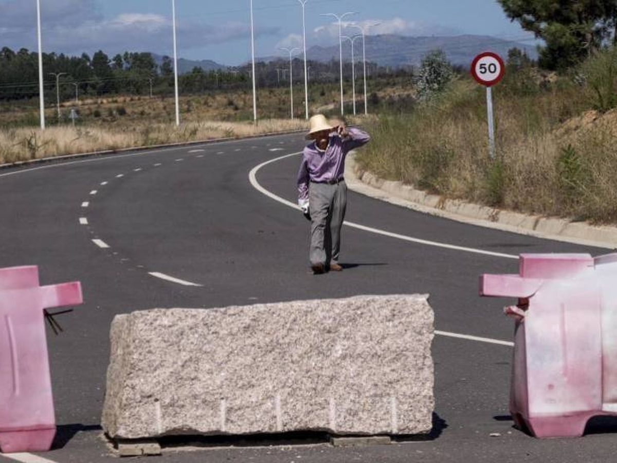 Foto: Uno de los antiguos propietarios de los terrenos pasea por la autovía que atraviesa la Plisan. (Anxo Iglesias)