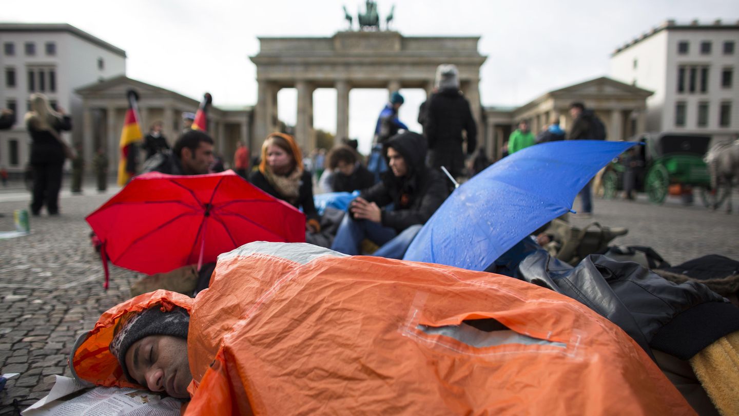 Iranian refugee sleeps in front of Brandenburg Gate during a hunger strike in Berlin