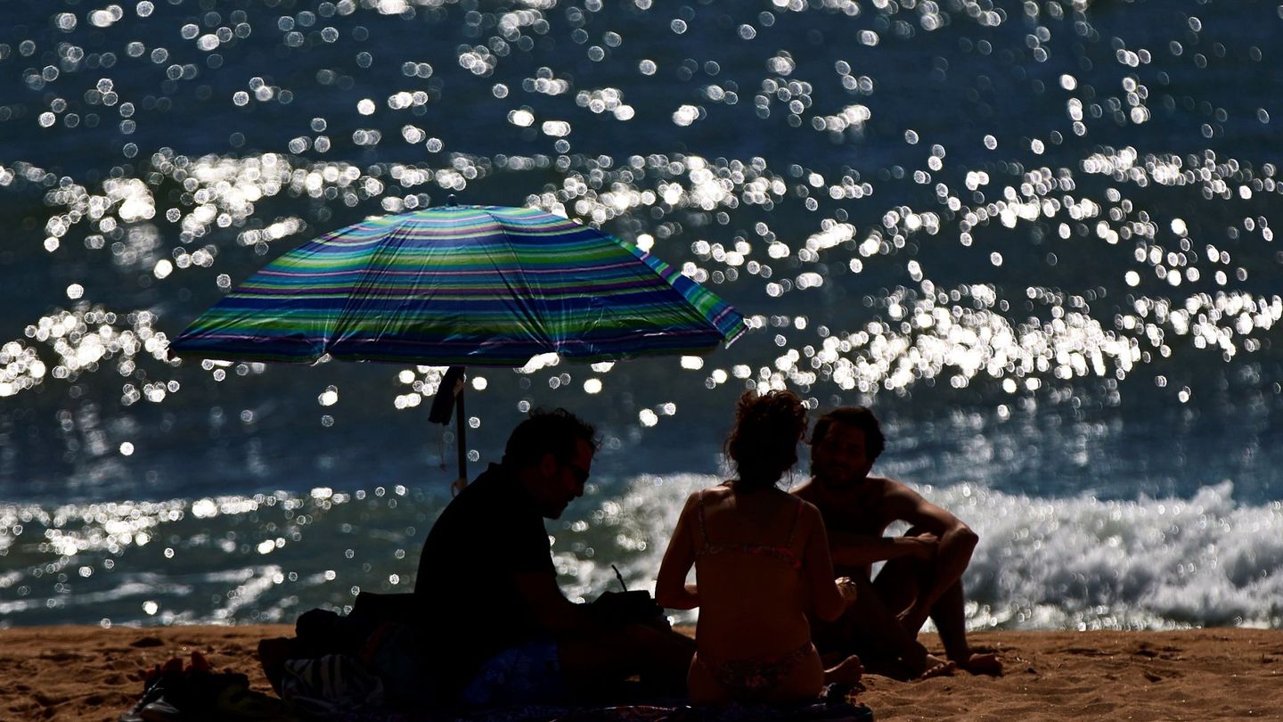 Varias personas toman el sol en la playa de la Barceloneta, en la Ciudad Condal, este 12 de junio. (EFE)