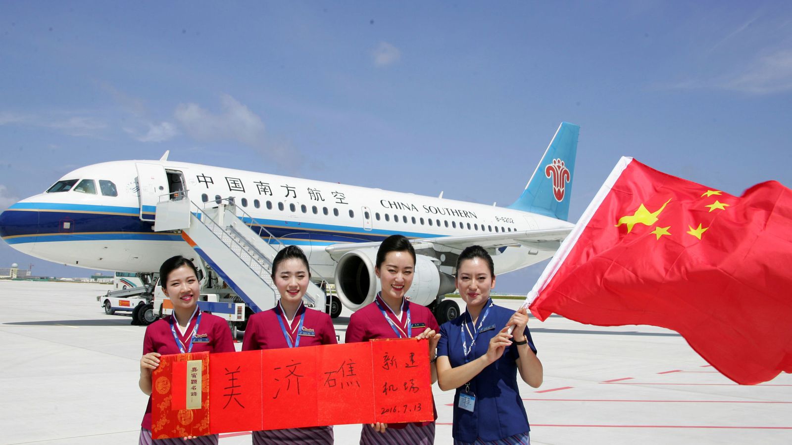 Foto: Tripulación del avión comercial chino enviado al nuevo aeropuerto construido en las Spratly, el 13 de julio de 2016 (Reuters)