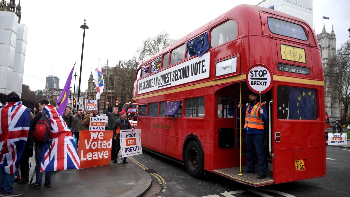 Manifestantes a favor del Brexit protestan frente a un autobús en el que pueden leerse consignas contrarias a la salida del país de la Unión Europea. (EFE)