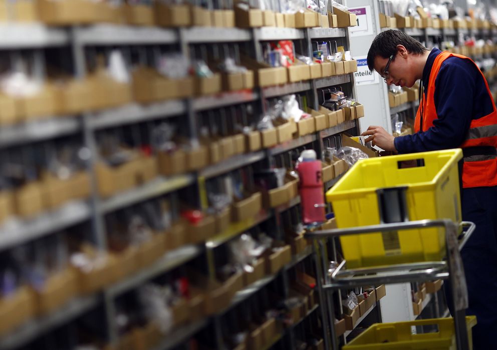 Foto: Un trabajador de Amazon clasifica envíos en la sede de Graben, Suiza (Reuters)