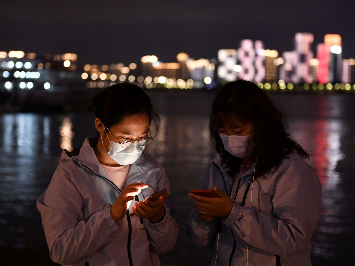 Dos médicos consultan sus teléfonos móviles en Wuhan. (Reuters)