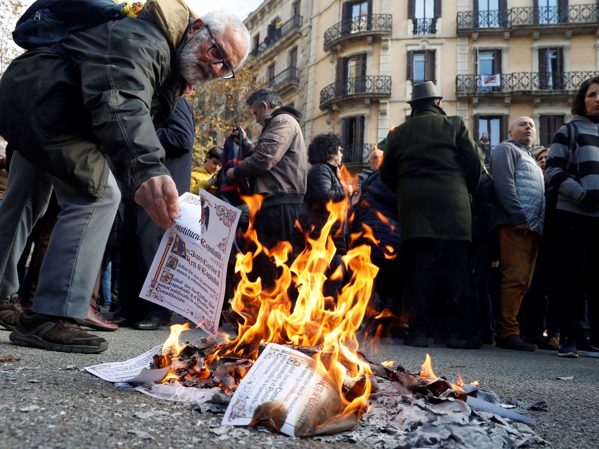 Foto: Varias personas queman ejemplares de la constitución. (EFE)