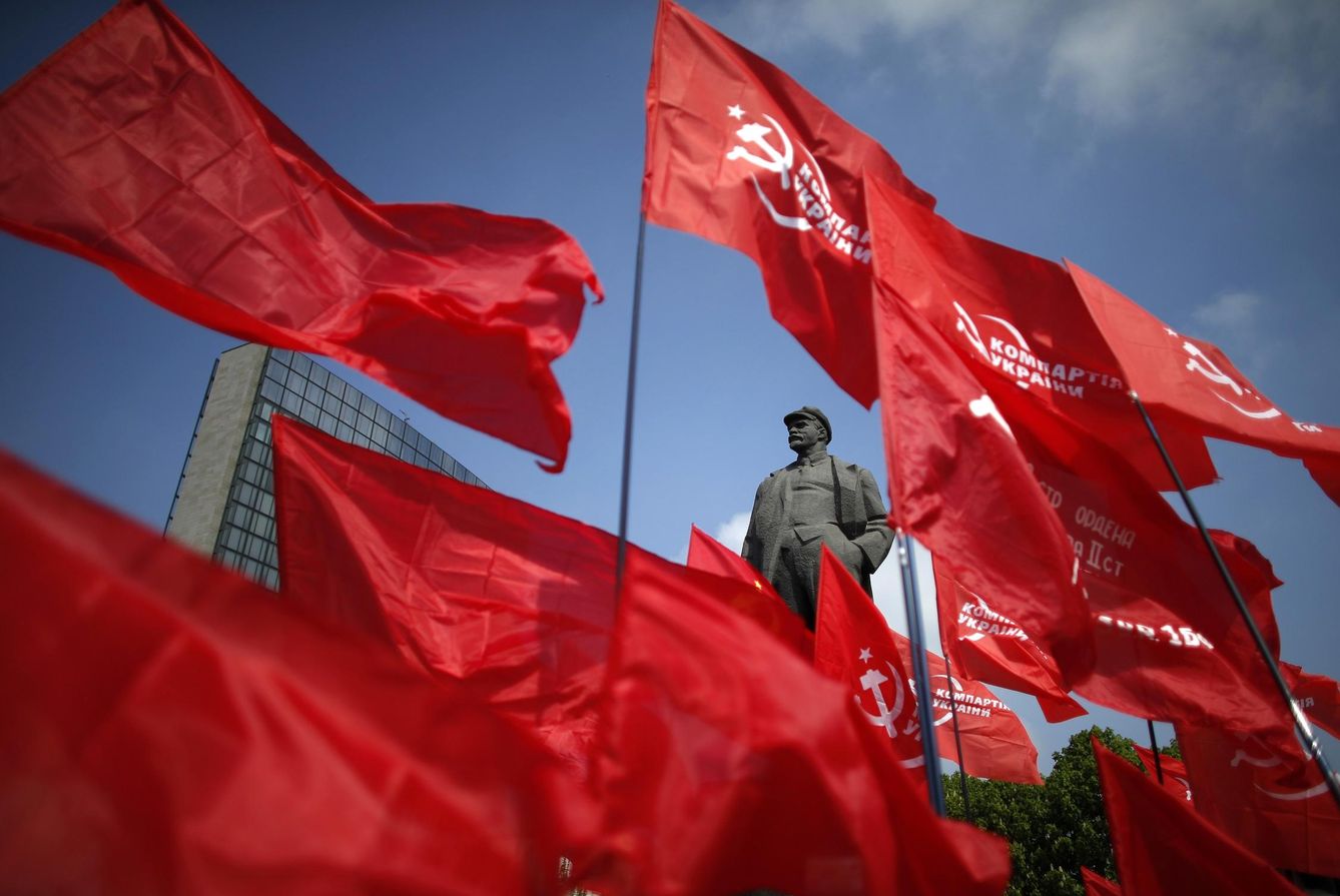 Comunistas ondean banderas cerca de una estatua de Lenin durante el Primero de Mayo, en Donetsk. (Reuters)