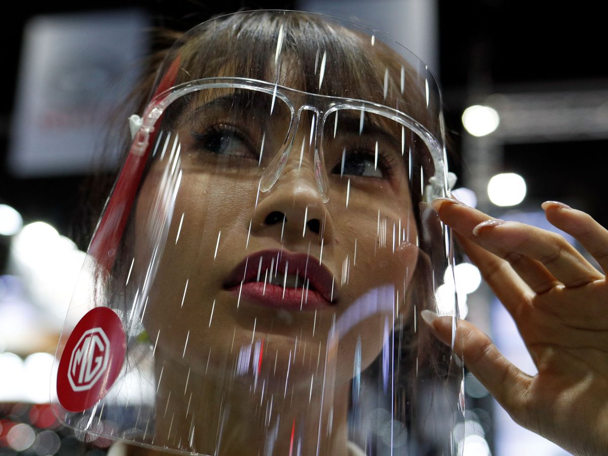 Foto: Una mujer con una protección facial en Bangkok. (Reuters)