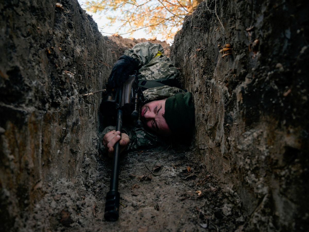 Foto: Un soldado ucraniano se refugia de un ataque aéreo en una trinchera en Demydiv. (Reuters/Maksim Levin)