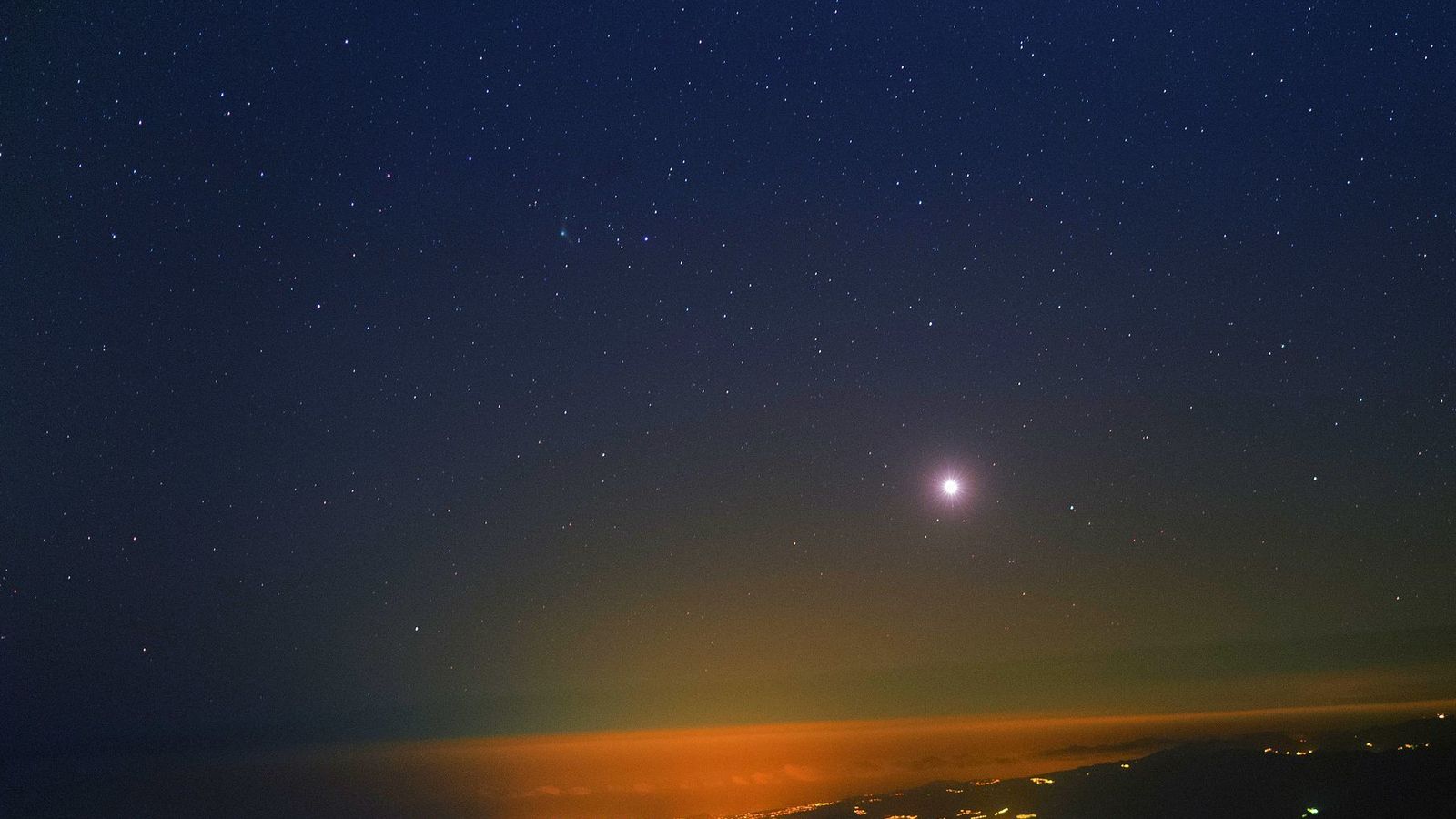 Foto: Vista desde el Observatorio del Teide (IAC). Se puede ver sobre el horizonte el planeta Venus y algo más arriba a la izquierda de éste el cometa Catalina. (Foto: StarryEarth/J.C. Casado)