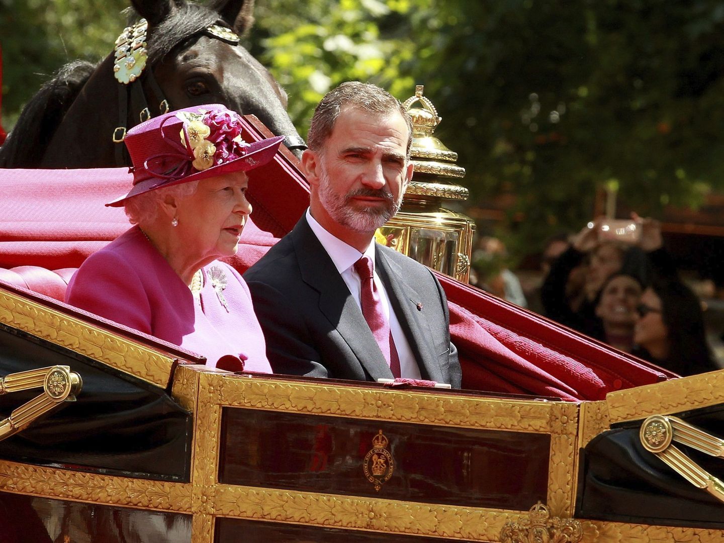 Isabel II, junto a Felipe VI, en su recorrido hacia el Palacio de Buckingham. (EFE)