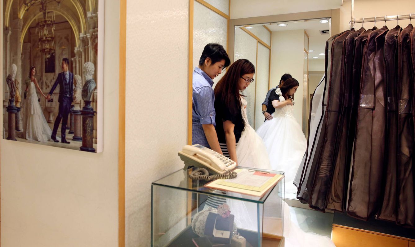 Daphne Chiang y Kenny Jhuang buscan un vestido de boda en una tienda de Taipéi, Taiwán. (Reuters)