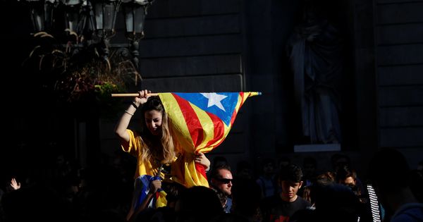 Foto: Un manifestante independentista ondea una estelada en la plaza Sant Jaume. (Reuters)