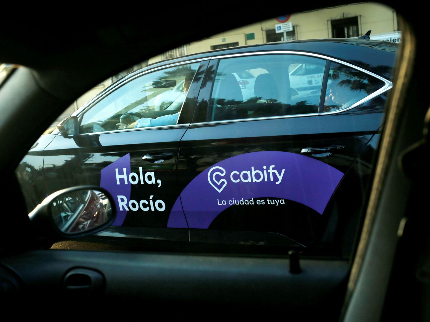 A Cabify taxi car is seen through the window of a car in Malaga, southern Spain August 3, 2018. REUTERS Jon Nazca