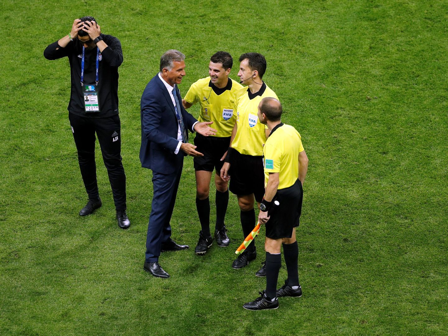 Soccer Football - World Cup - Group B - Iran vs Spain - Kazan Arena, Kazan, Russia - June 20, 2018   Iran coach Carlos Queiroz speaks with referee Andres Cunha and match officials after the match      REUTERS John Sibley