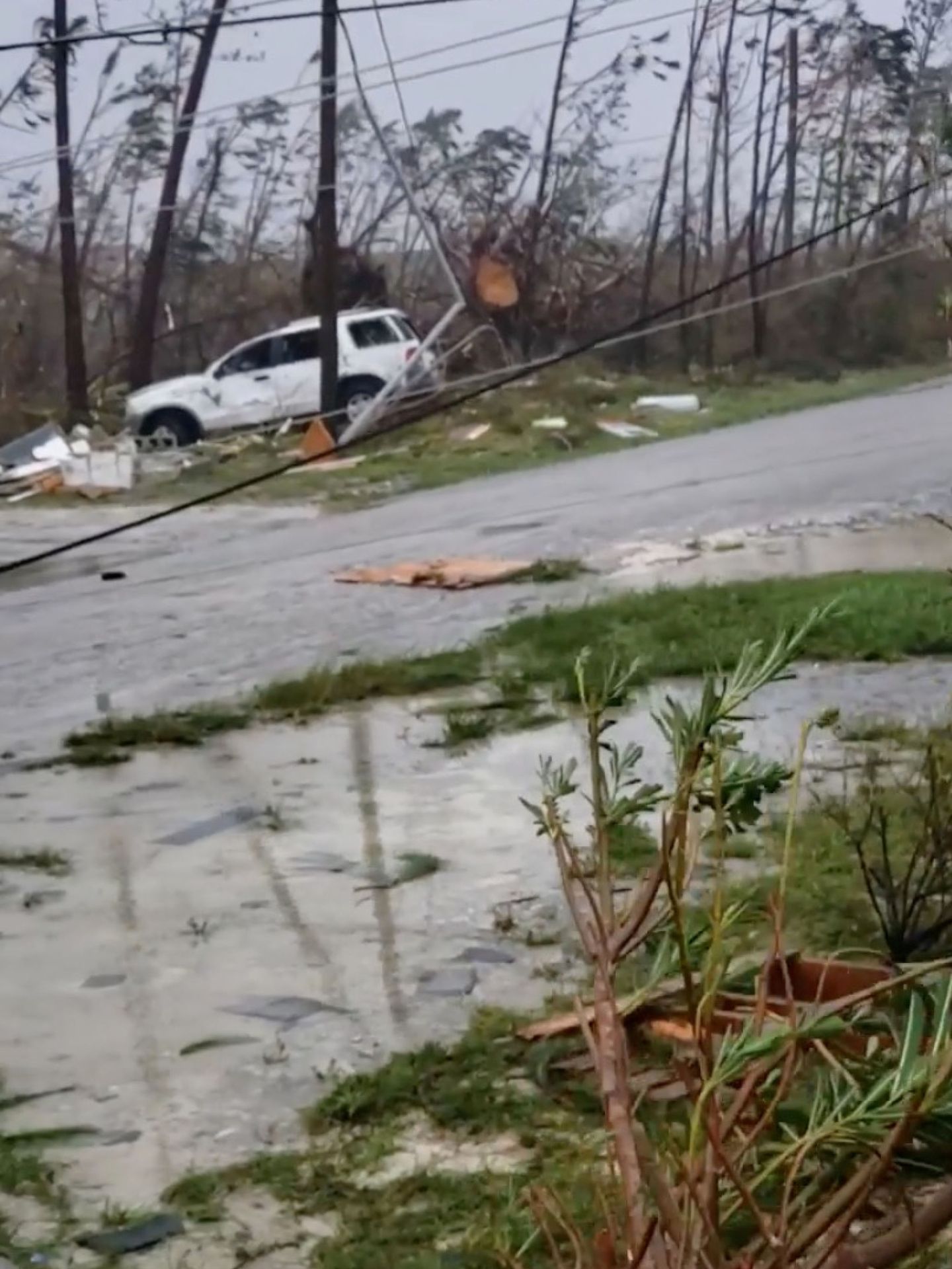 Uprooted trees, fallen power lines and debris scatter on a road as Hurricane Dorian sweeps through Marsh Harbour, Bahamas, September 1, 2019, in this still image taken from a social media.  Ramond A King via REUTERS THIS IMAGE HAS BEEN SUPPLIED BY A THIRD PARTY. MANDATORY CREDIT. NO RESALES. NO ARCHIVES.