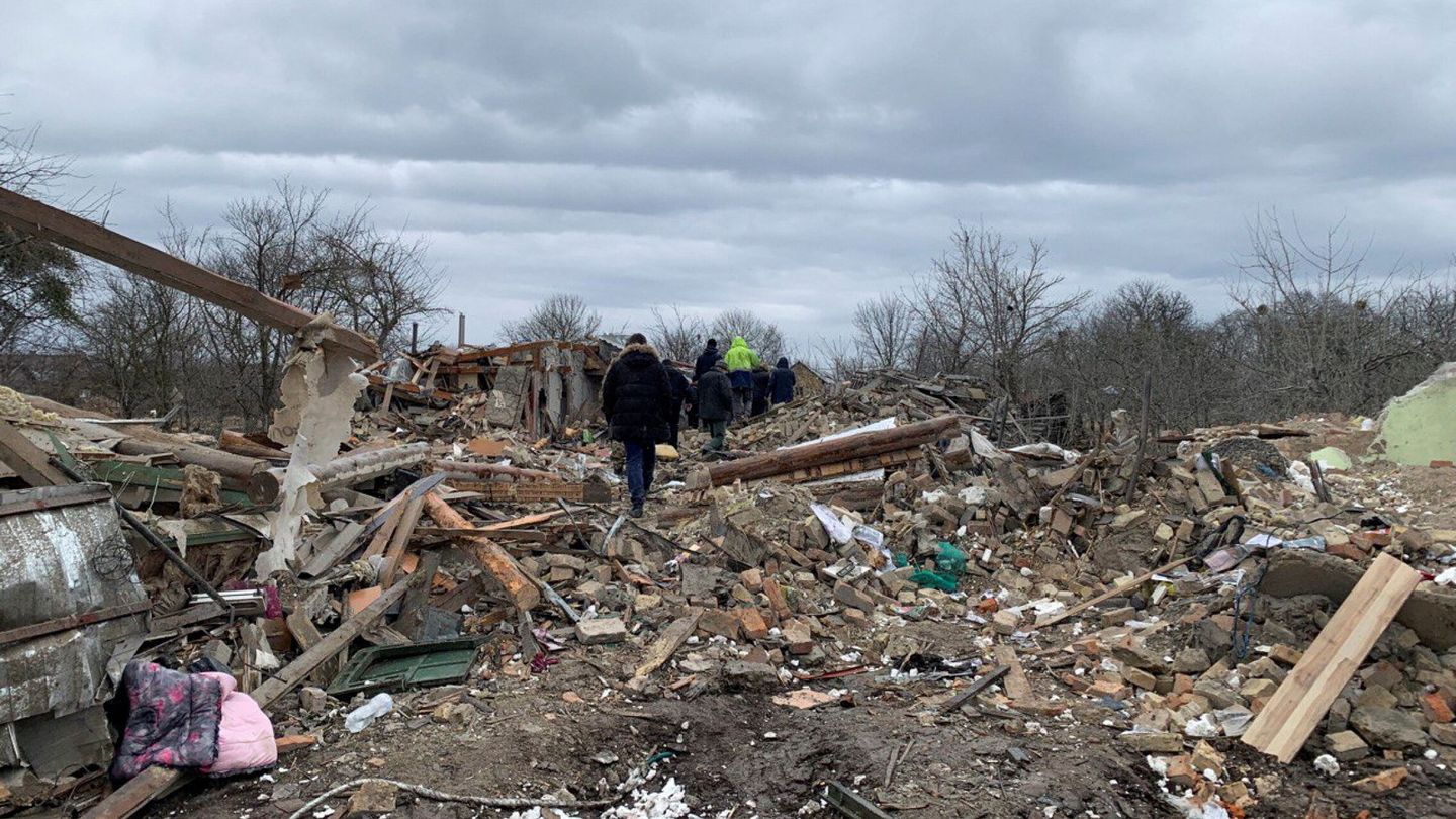 Local residents walk among remains of residential buildings destroyed by a Russian missile strike, amid Russia's attack on Ukraine, near the town of Zolochiv, Lviv region, Ukraine March 9, 2023. REUTERS Andriy Perun
