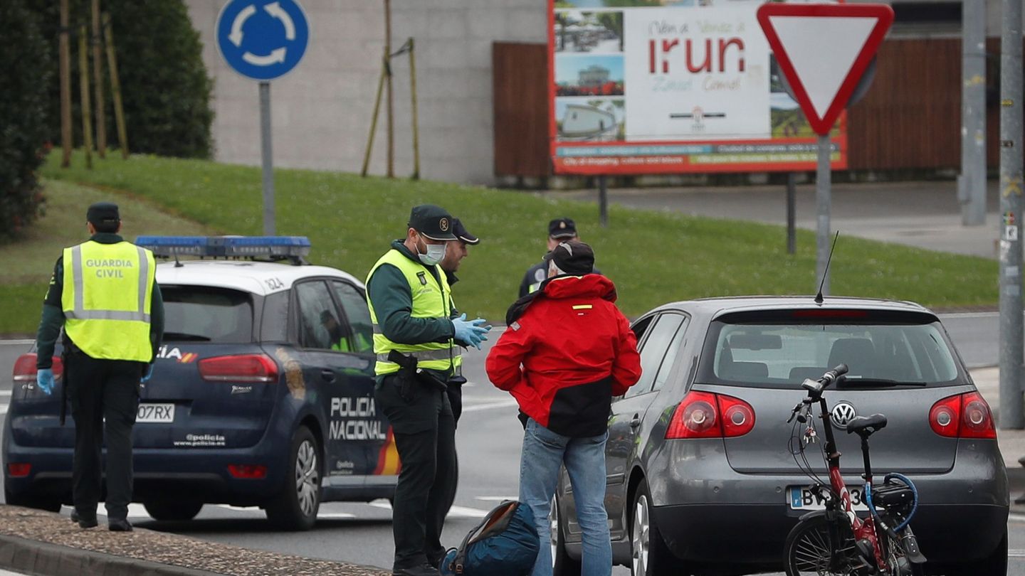 Agentes de la Guardia Civil y Policía Nacional niegan el paso a España a un ciclista en la frontera de Behobia. (EFE)