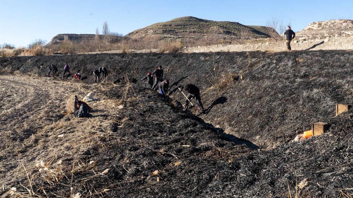 Foto: Varias personas excavan una acequia en la Alpujarra, en Andalucía | MEMOLab