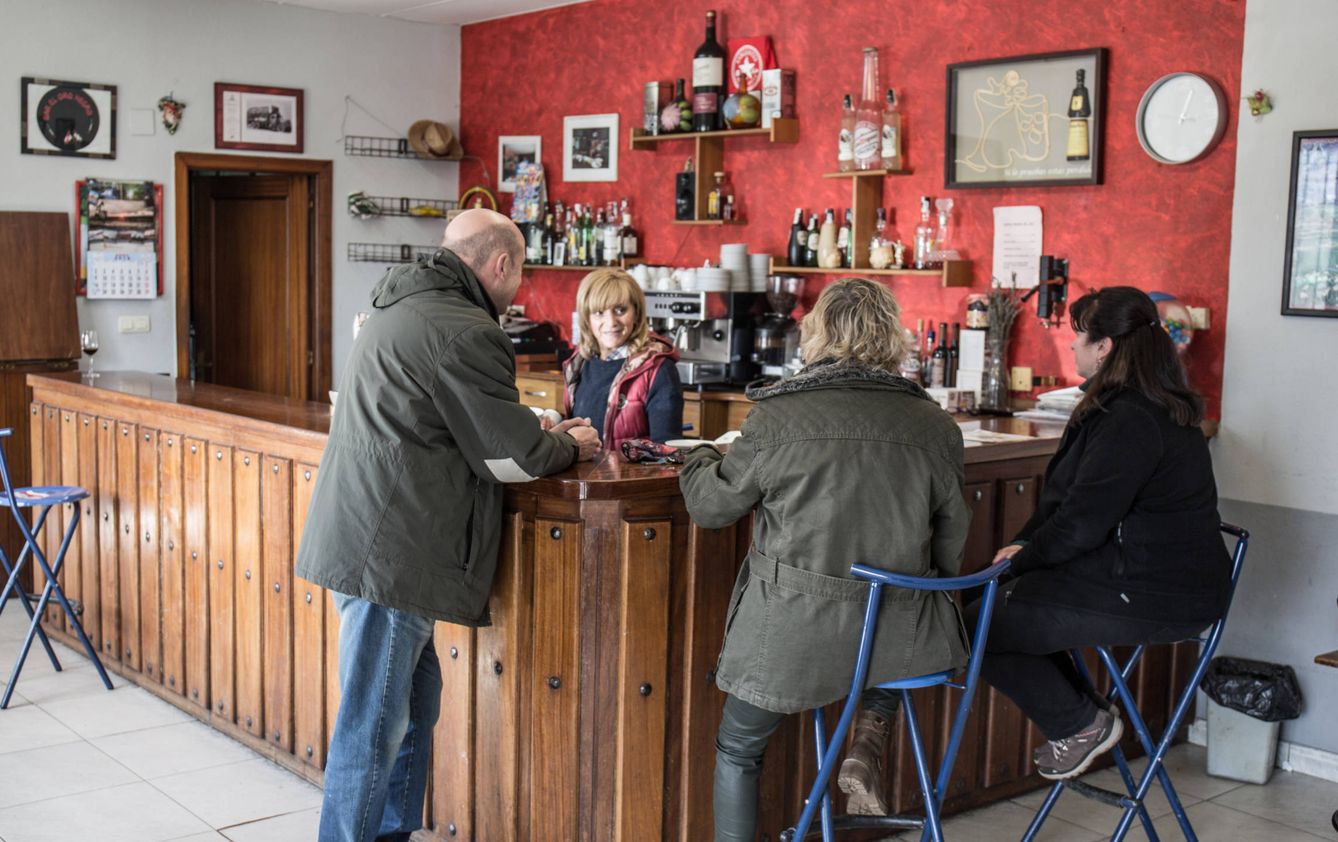 Mariví Gallo junto a tres clientes del bar, que podría cerrar este verano. (D.B.)