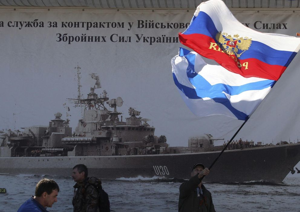 Foto: Varias personas ondean banderas rusas en las inmediaciones de la base de la Fuerza Naval ucraniana de Sebastopol