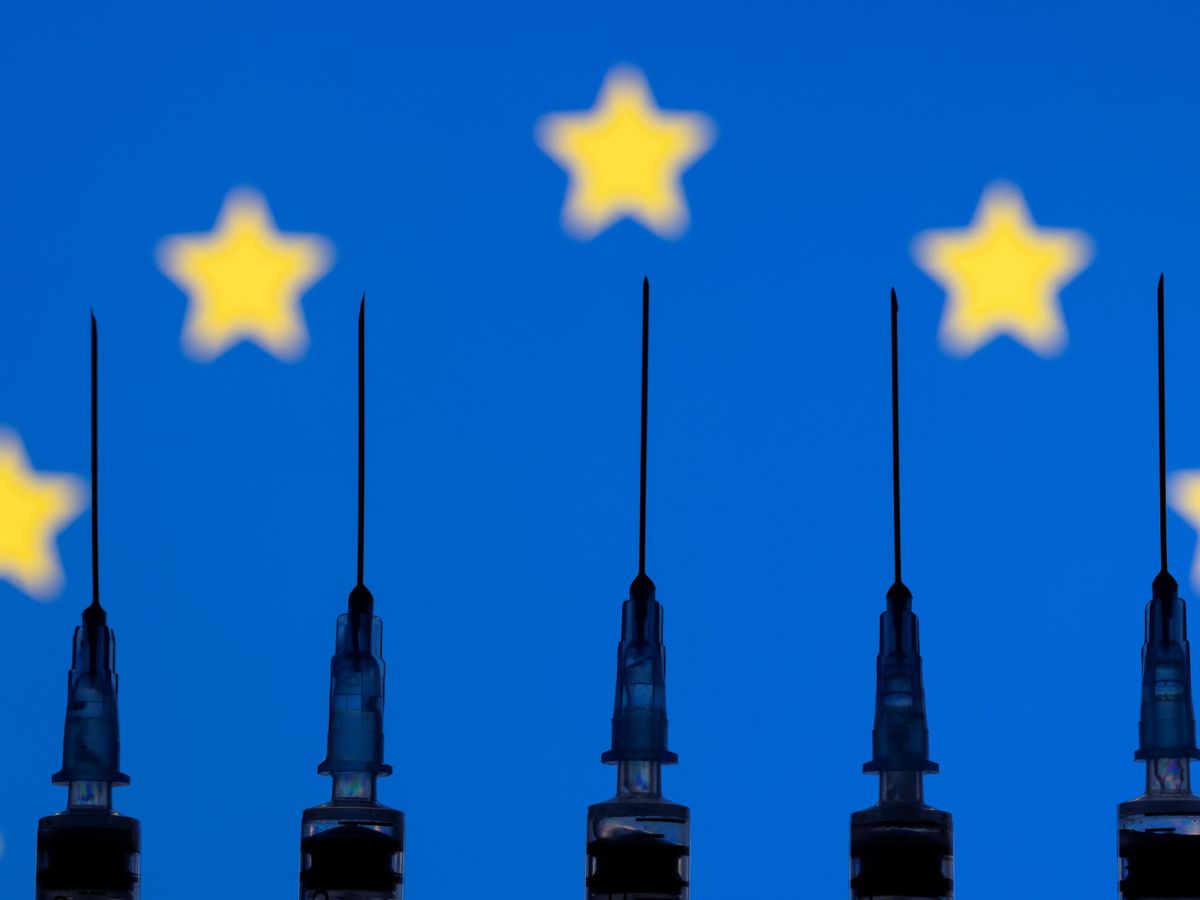 Foto: Jeringuillas de vacunación frente a una bandera europea. (Reuters)