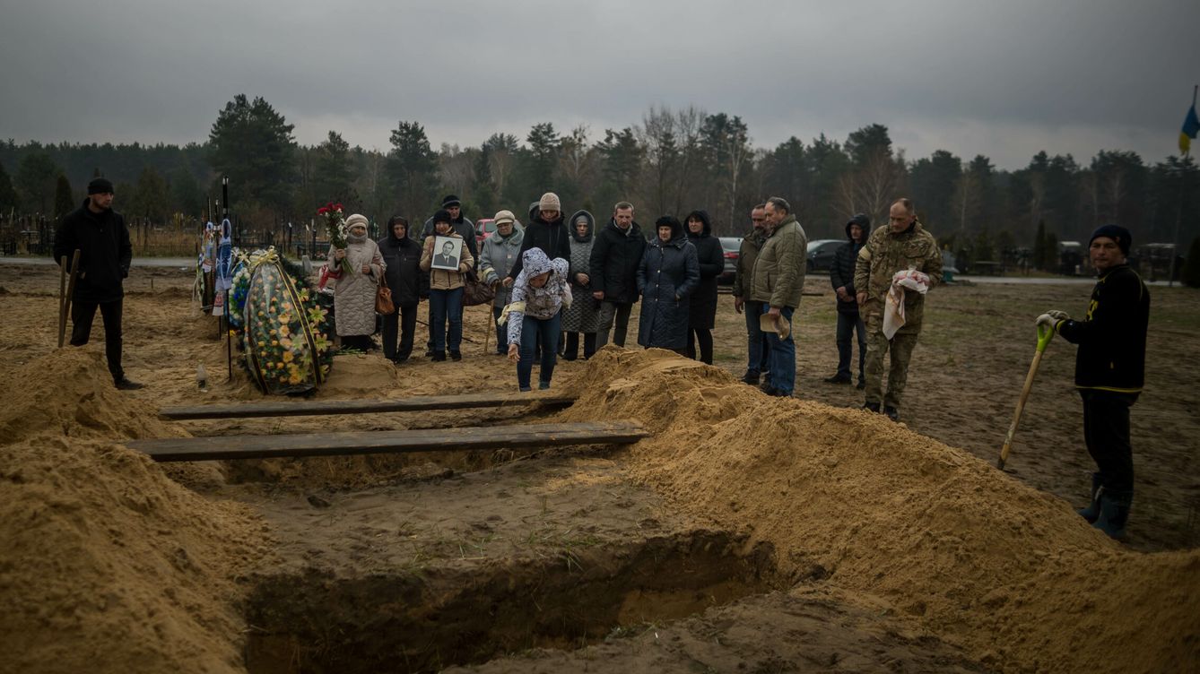 Foto: Familiares asisten al entierro de una persona que murió en un refugio subterráneo mientras se intentaba proteger de los bombardeos, en Irpin (Ucrania). (EFE / Miguel Gutiérrez) 