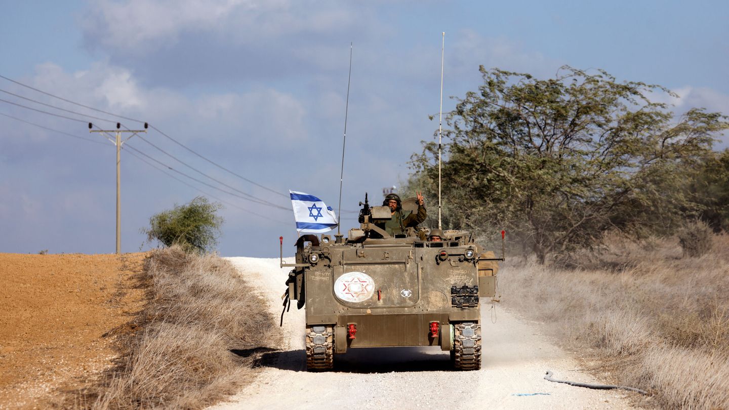 An Israeli soldier gestures as he rides an APC near Israel's border with the Gaza Strip, in southern Israel October 19, 2023. REUTERS Amir CohenA
