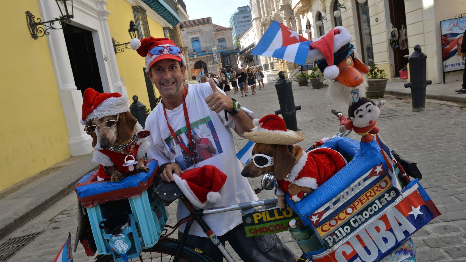Foto: Un vendedor ambulante, anunciando sus productos con sus perros en La Habana, el 23 de diciembre de 2015. (EFE)