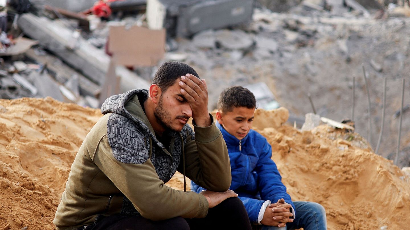 Palestinians react as they sit at the site of an Israeli strike on a house, amid the ongoing conflict between Israel and the Palestinian Islamist group Hamas, in Rafah in the southern Gaza Strip February 23, 2024. REUTERS Ibraheem Abu Mustafa     TPX IMAGES OF THE DAY
