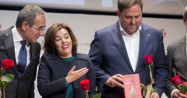 Foto: La vicepresidenta del Gobierno, Soraya Sáenz de Santamaria (c) regala un libro al vicepresidente de la Generalitat de Cataluña, Oriol Junqueras (d), en presencia del presidente del Gremio de Editores, Patrici Tixis. (EFE)