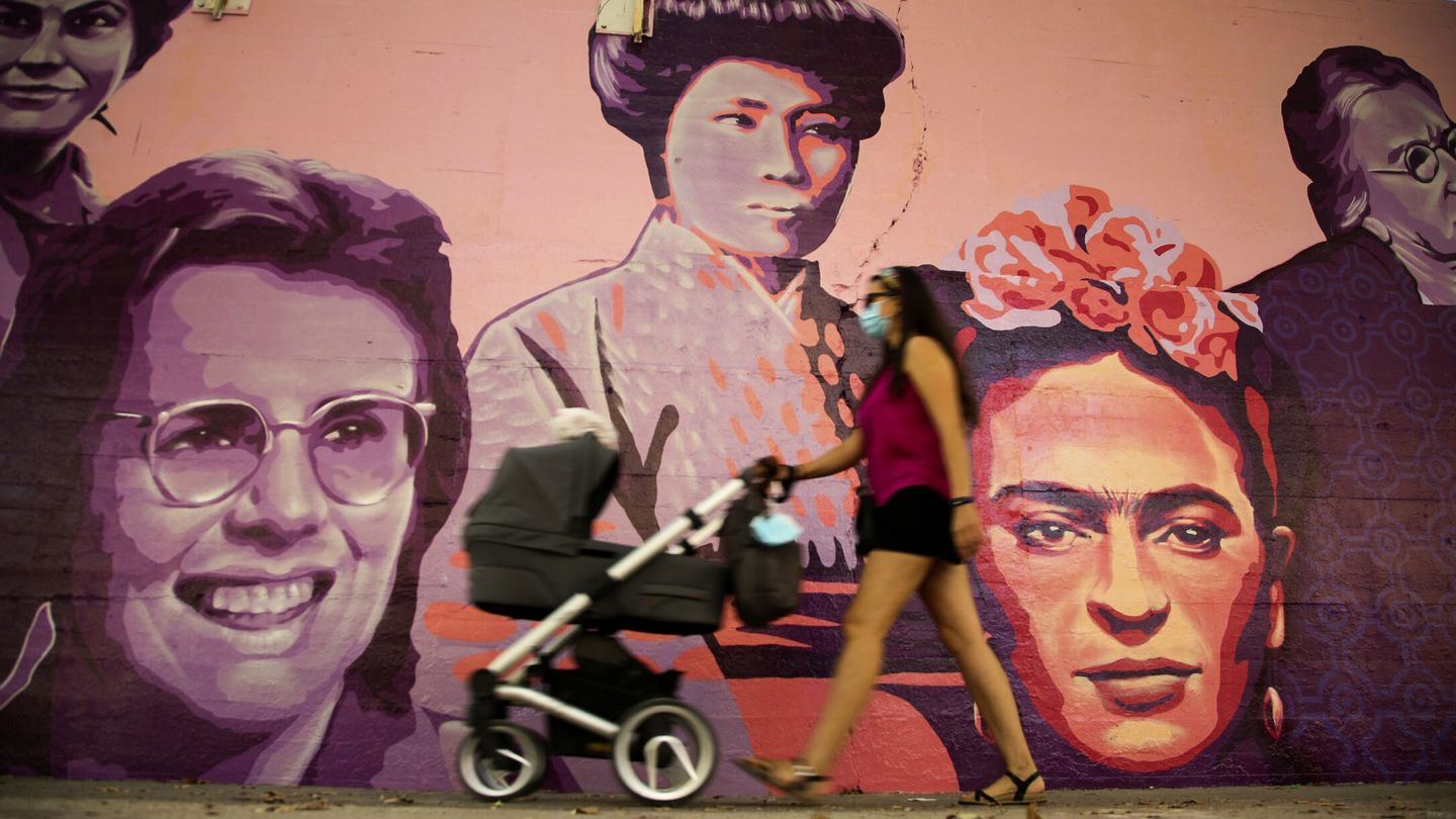 Una mujer camina junto al mural de las mujeres del barrio de Ciudad Lineal en Madrid, que fue atacado en un acto vandálico machista. (EFE/David Fernández)