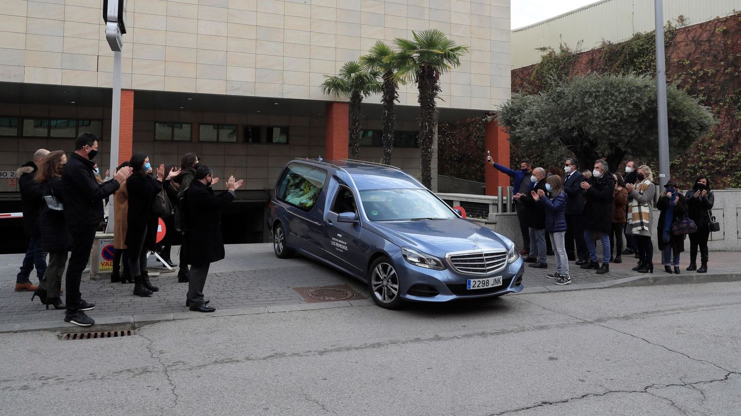 Amigos y familiares aplauden al coche fúnebre que lleva los restos mortales de Enrique San Francisco. (EFE)