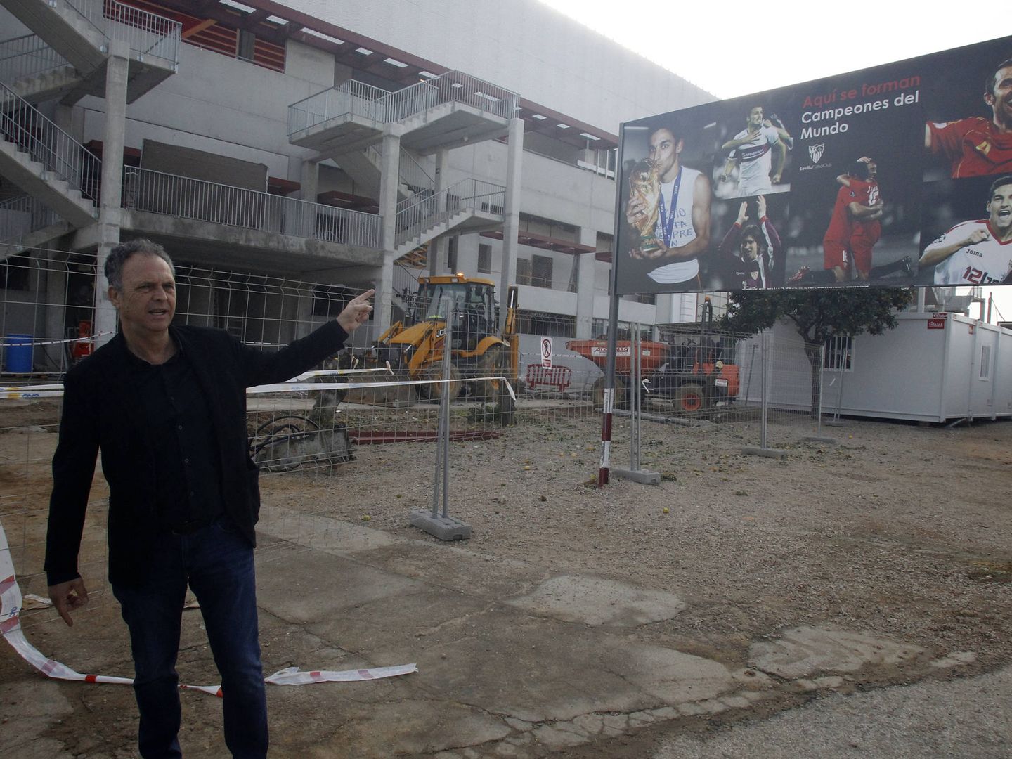 Caparrós señala el cartel que luce orgulloso el Sevilla a las puertas de su ciudad deportiva (SFC)