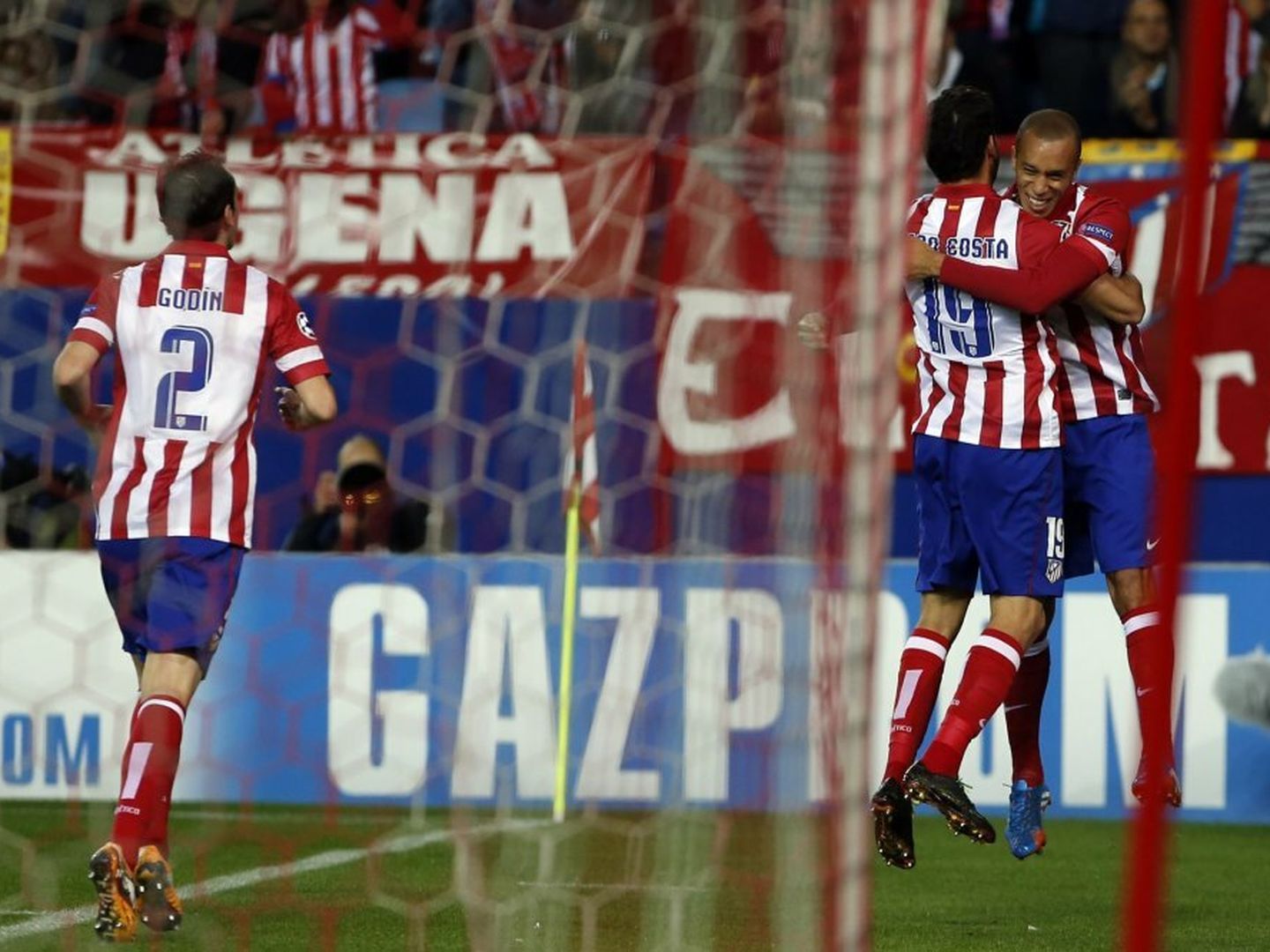 Atletico madrid's miranda celebrates scoring against austria vienna with teammate diego costa during their champions league group g soccer match at vicente calderon stadium in madrid