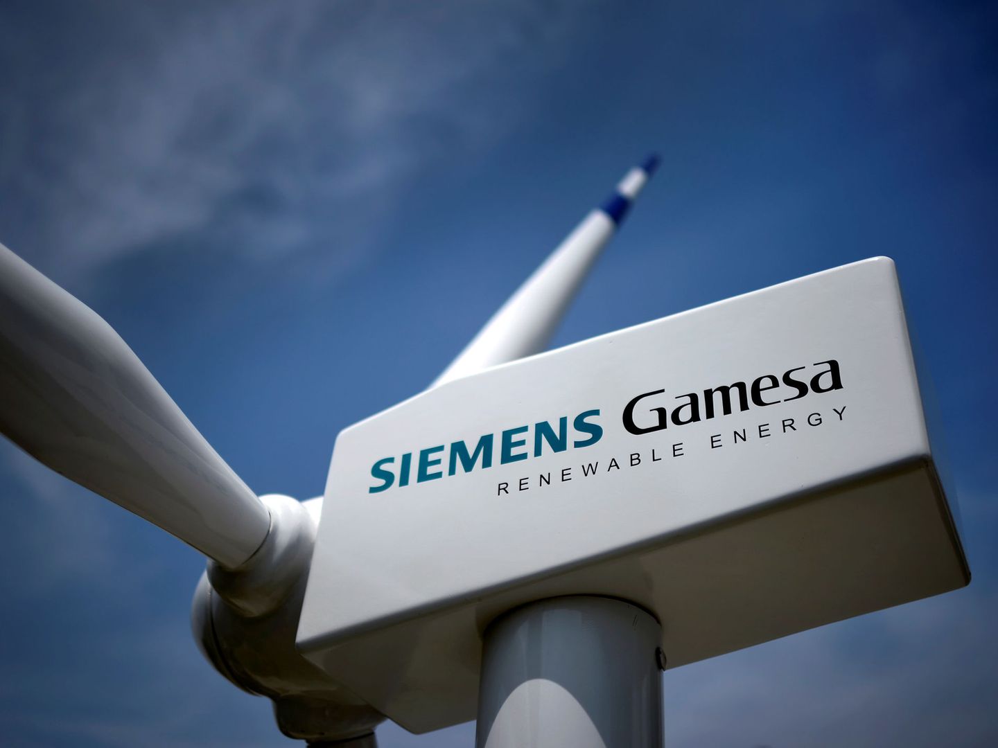FILE PHOTO: A model of a wind turbine with the Siemens Gamesa logo is displayed outside the annual general shareholders meeting in Zamudio, Spain, June 20, 2017. REUTERS Vincent West File Photo
