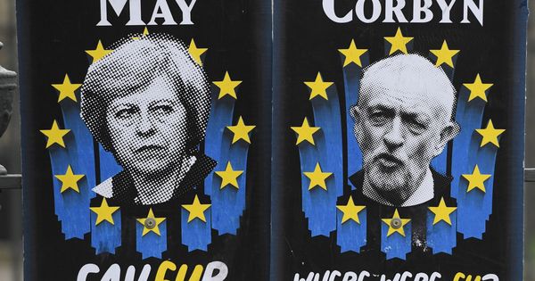 Foto: Dos carteles con la imagen de la primera ministra británica, Theresa May, y del líder del Partido Laborista, Jeremy Corbyn. (EFE)