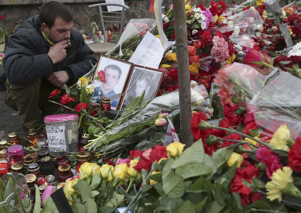 Foto: Un hombre ante un altar improvisado en Kiev en memoria de los caídos en los enfrentamientos (Reuters).