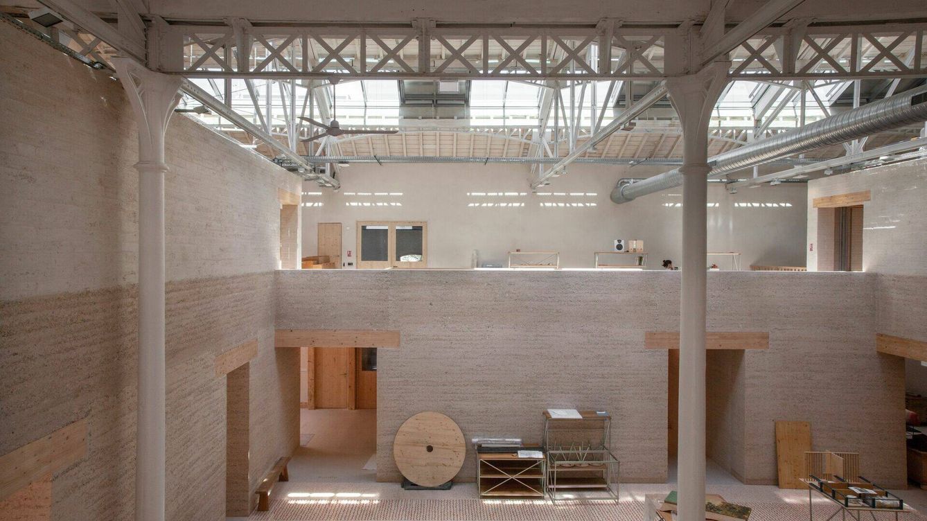 Foto: Interior del almacén eléctrico, sede del Atelier Luma en Arles, con las paredes de tierra apisionada y compactada. © Joseph Halligan 