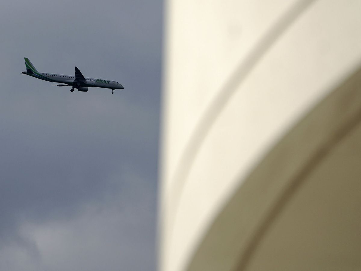Foto: Un avión sobrevuela el Centro Niemeyer aproximándose al aeropuerto de Santiago del Monte. (EFE/Paco Paredes)