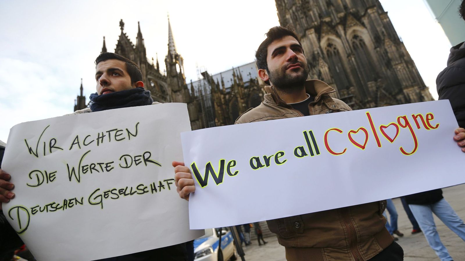 Foto: Sirios sostienen pancartas contra las agresiones durante una manifestación en Colonia, el 16 de enero de 2016 (Reuters).