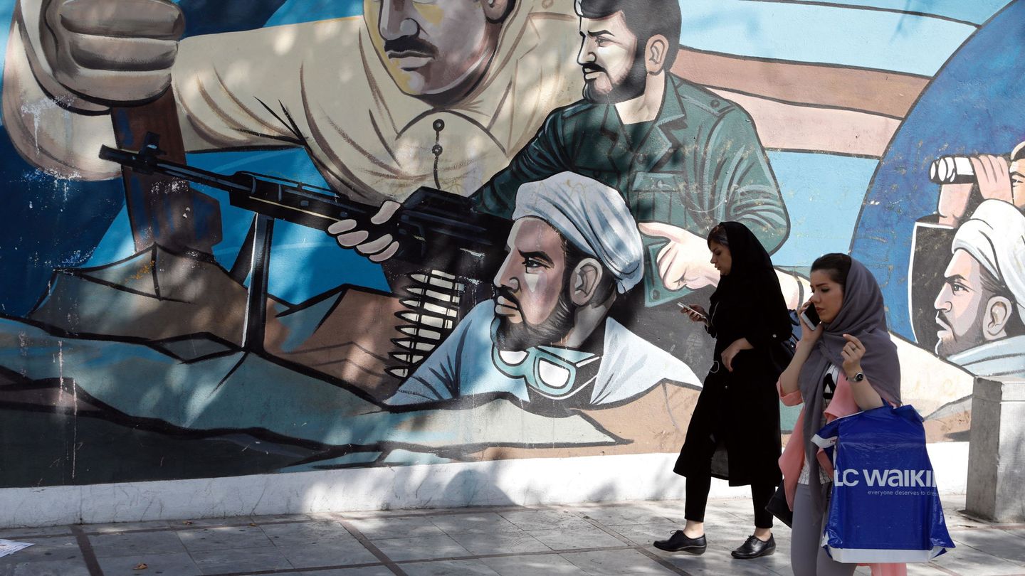 Dos mujeres pasan por delante de un mural en homenaje a los mártires en Teherán, el 22 de julio de 2018. (EFE)