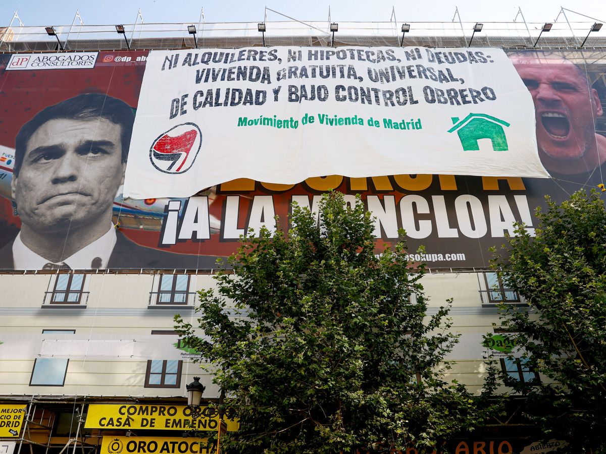 Foto: La plataforma Movimiento de Vivienda cubre la pancarta desplegada por Desokupa en Madrid. (EFE/Mariscal) 