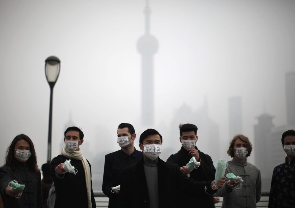 Foto: Un grupo de personas distribuye máscaras a los transeúntes en el centro de Shangái (Reuters).