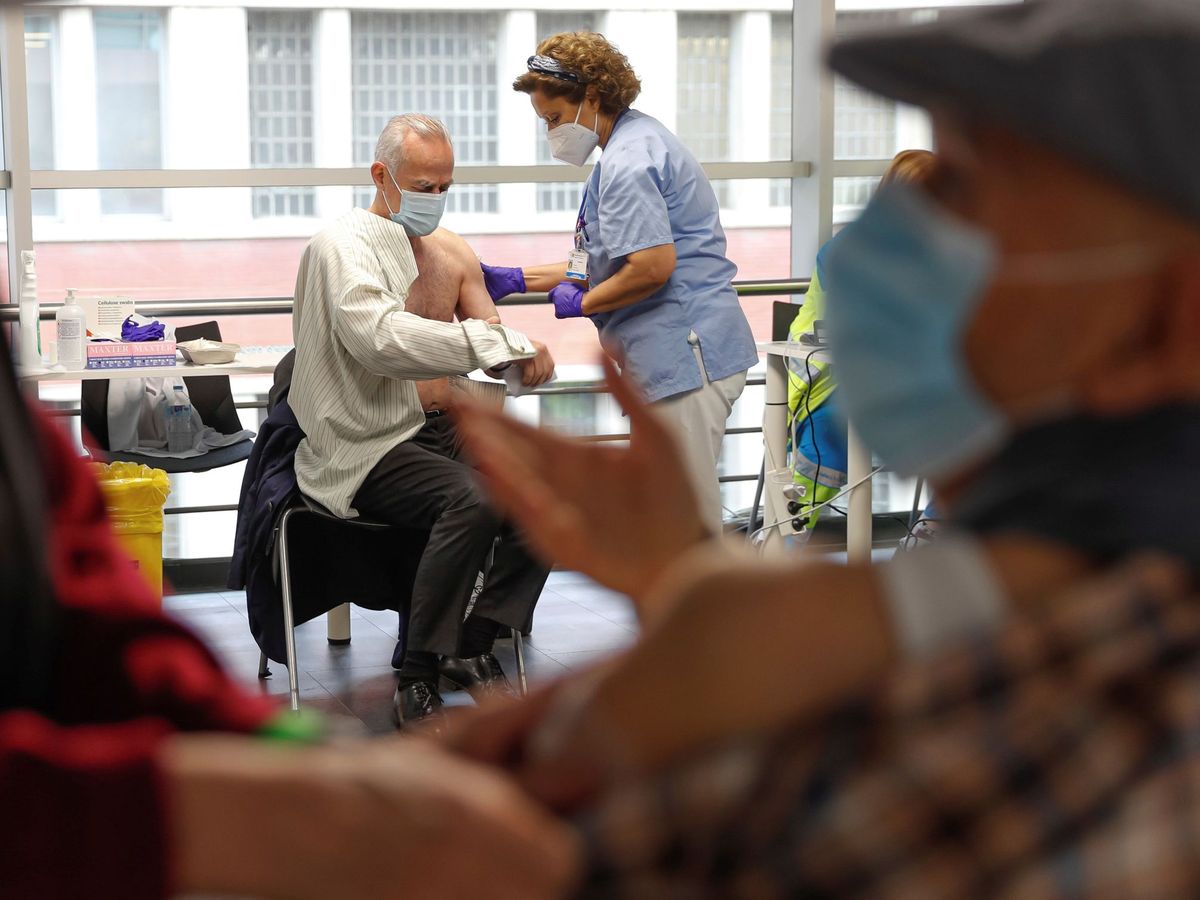 Foto: Varias personas reciben sus respectivas dosis de vacuna en el WiZink Center de Madrid. (EFE)