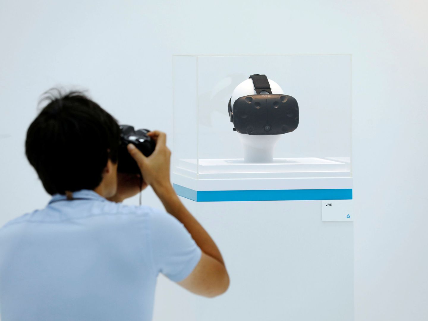 A photographer takes photo of HTC's Vive Virtual Reality (VR) goggles at HTC headquarters, in Taipei, Taiwan September 21, 2017. REUTERS Tyrone Siu